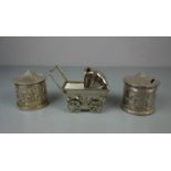 3 SPARDOSEN / SPARBÜCHSEN: Karusselle und Kinderwagen / three money boxes, 20. Jh., silberfarbenes