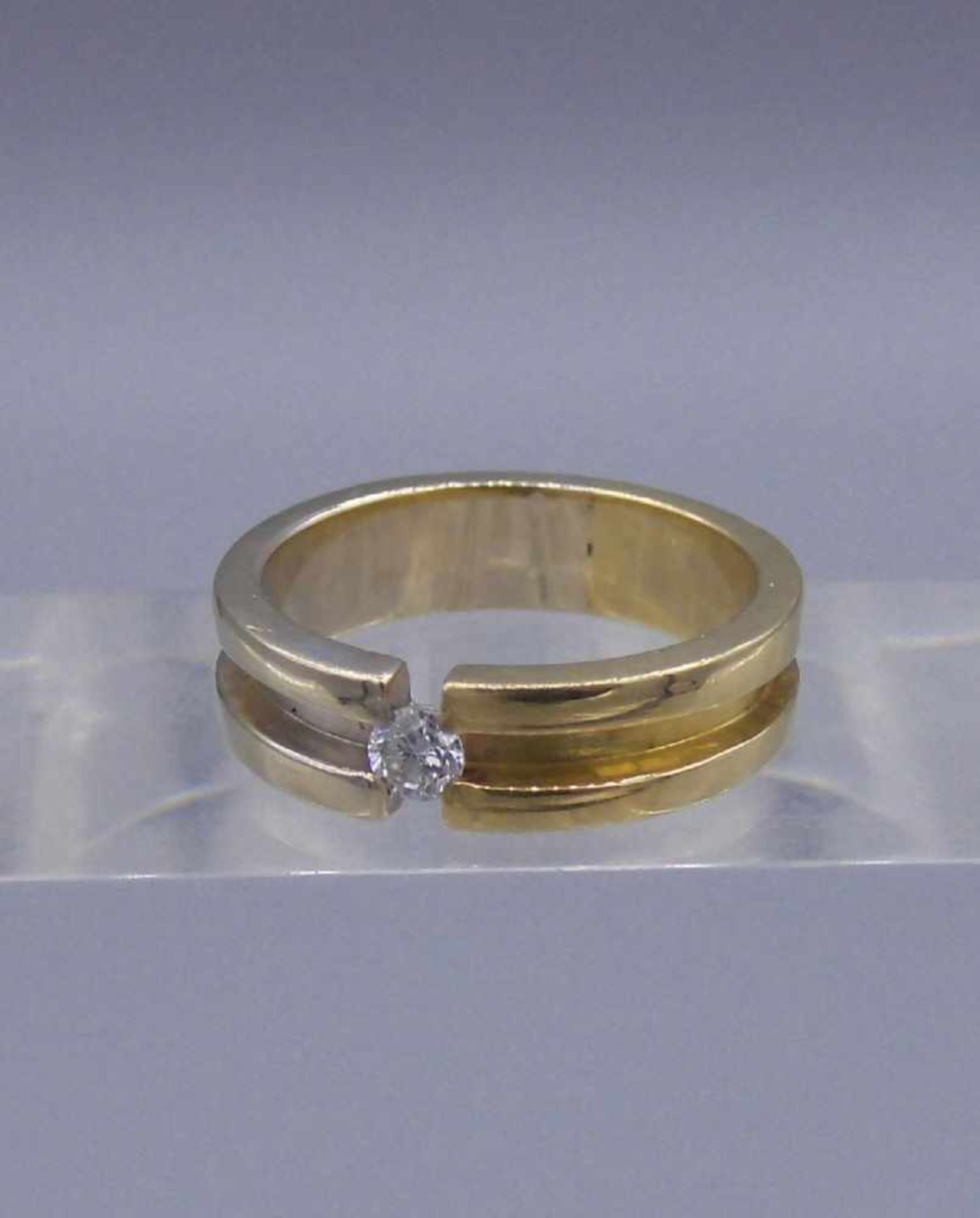 SOLITÄRRING in der Anmutung eines Spannringes, 750er Gold bicolor (7,5 g); profilierte und massiv