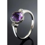 Zarter rhodinierter GG 585 Bandring mit ovalem Amethyst und zwei kleinen Brillanten (zus. ca. 0.