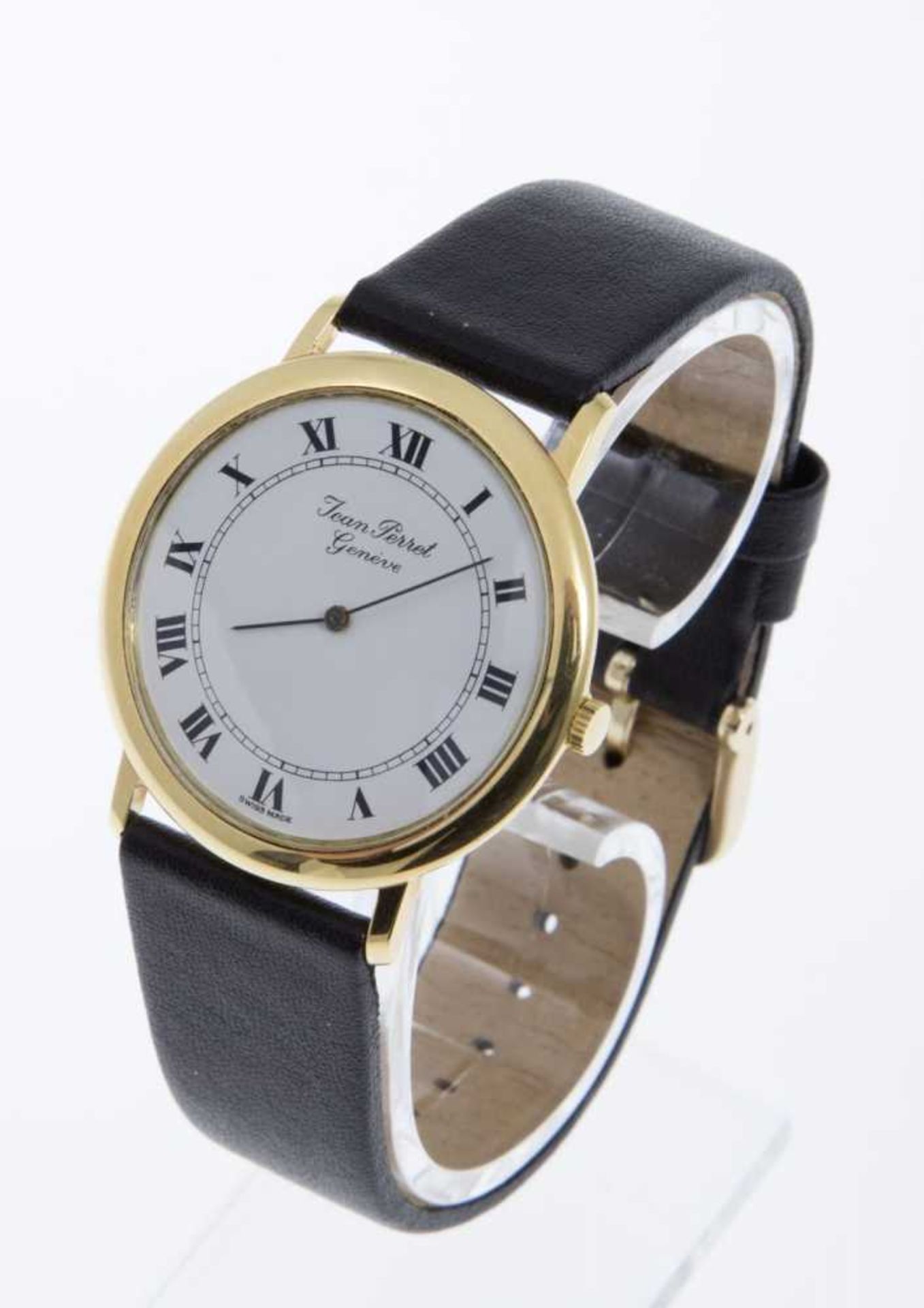 Elegante Armbanduhr von Jean PerretFlaches rundes Gehäuse aus Gelbgold 750. Weißes Zifferblatt mit