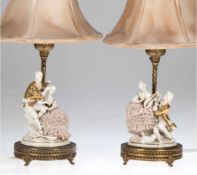 Paar Tischlampen, um 1900, gemarkt, Porzellanfigur auf Messingfuß, 1-flammig, hellerSeidenschirm, H.