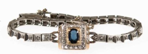 Armband, 585er WG/GG, 9,9 g, mit ovalem, mittelblauem Saphir, eingerahmt von 16 Brillantenund 6