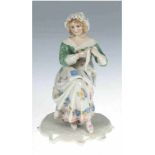 Porzellanfigur "Sitzende Frau mit Buch", Volkstedt, Ens, polychrom bemalt, H. 15 cm- - -23.80 %