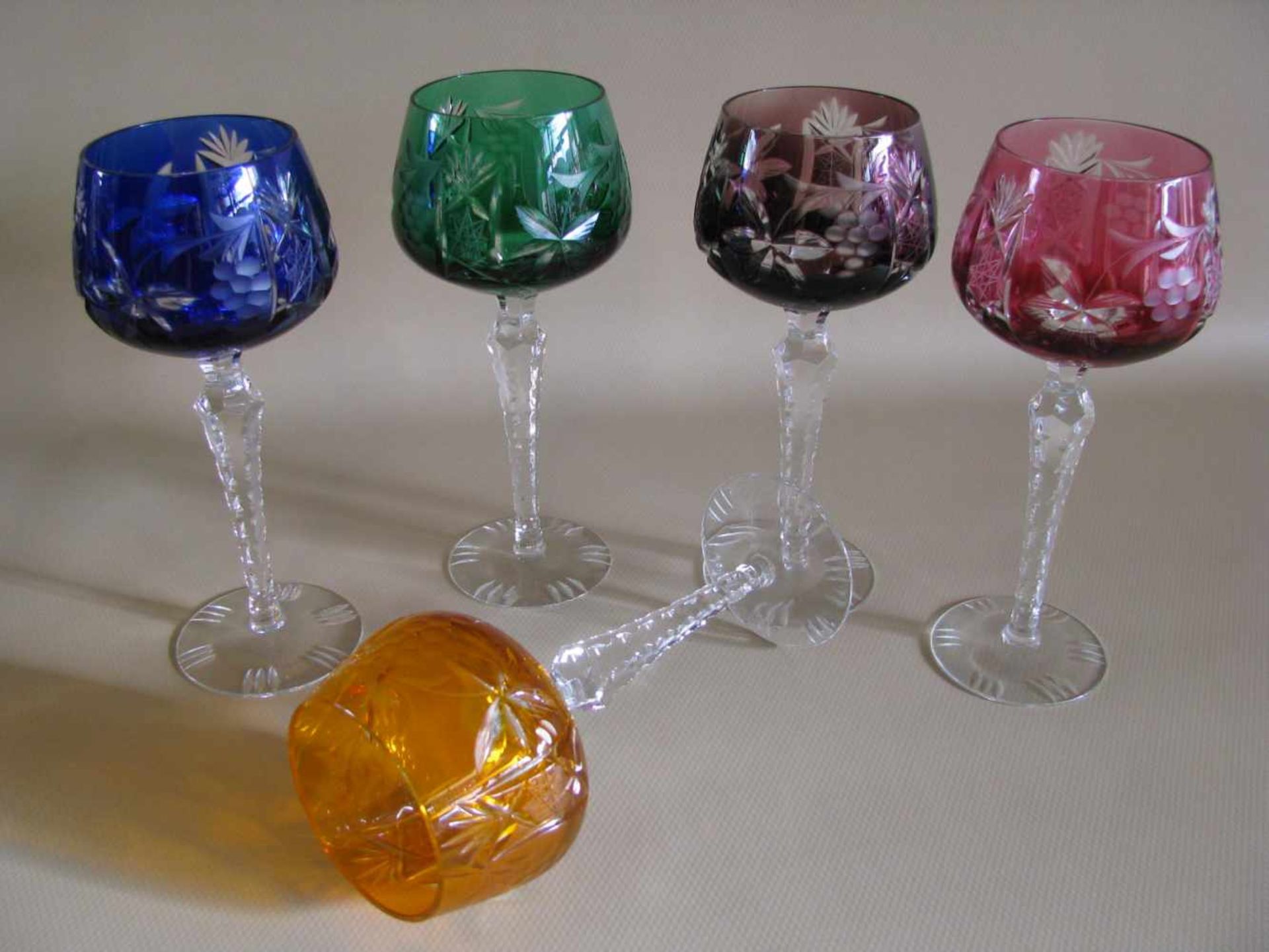 5 Weinrömer, Bleikristall reich beschliffen, verschieden farbige Kuppas, h 20 cm, d 8,5 cm.
