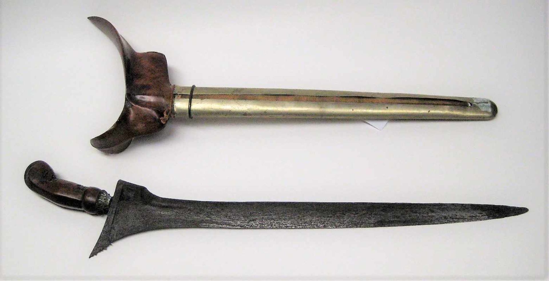 Kris, Indonesien, 19. Jahrhundert, Damaszener Klinge, beschnitzter Holzgriff, l 43 cm, b 16 cm.