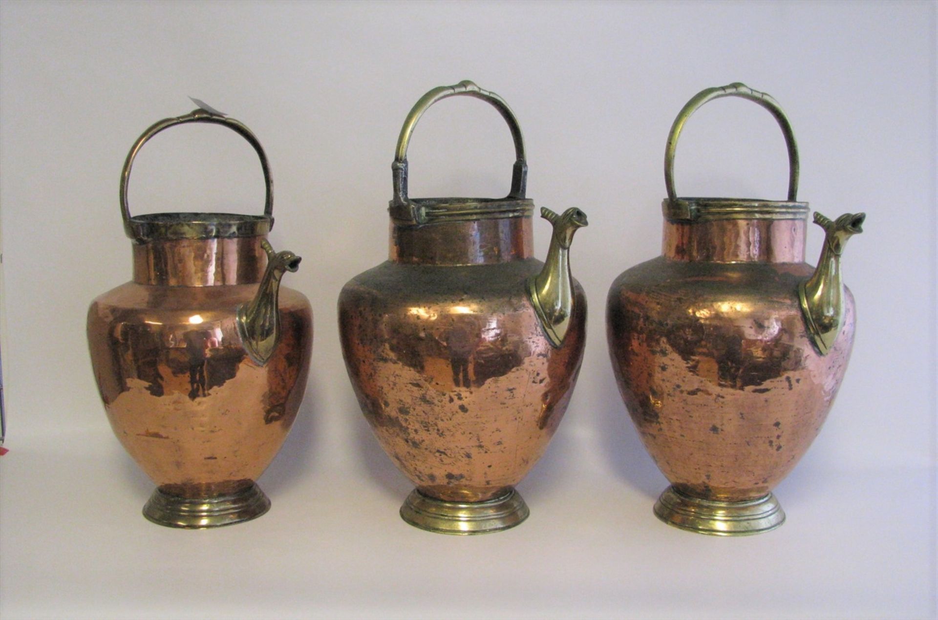 3 Henkelkannen, 19. Jahrhundert, Kupfer und Messing, h 47 cm, d 23 cm.- - -19.00 % buyer's premium
