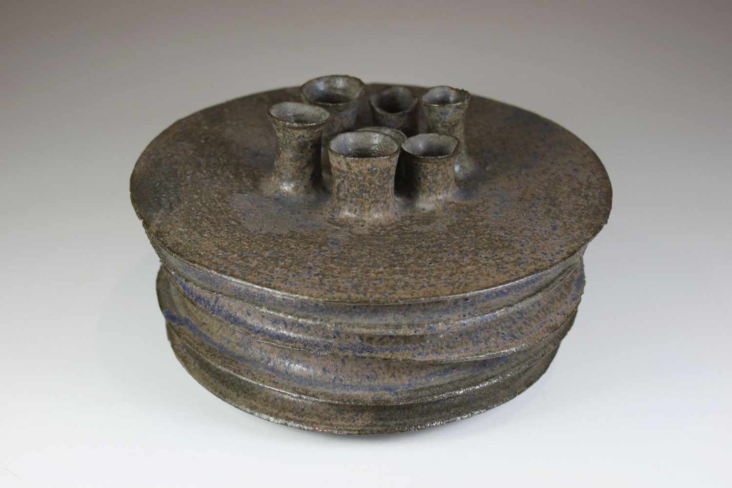 Keramikvase, sieben schmale Öffnungen, braun-grau mit blauen Elemten, Ritzmarke am Boden, datiert