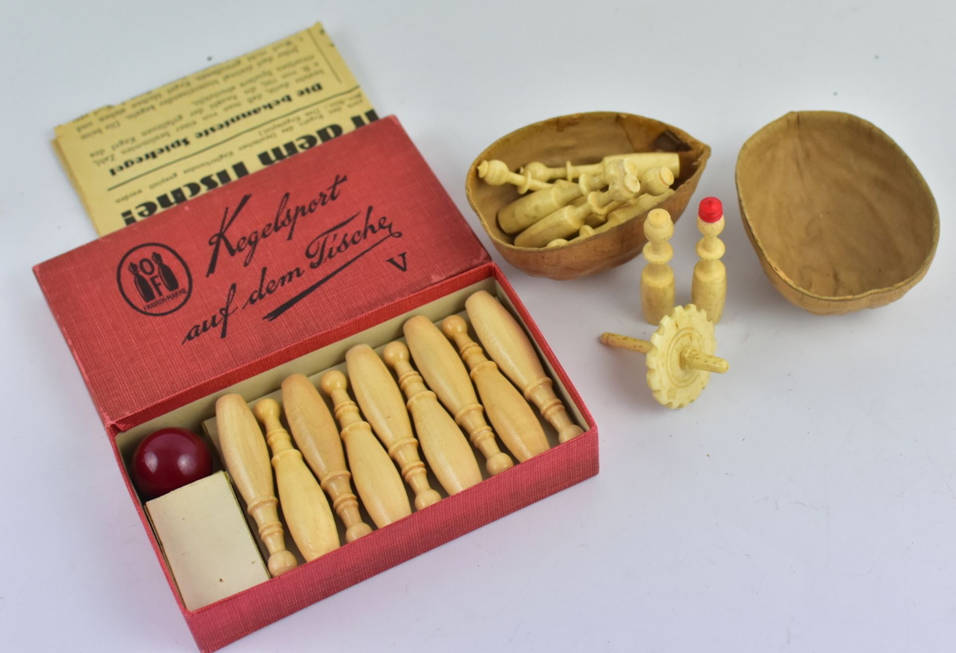 2 Tisch-Kegelspiele, einmal OF Fabrikmarke, um 1930, Holz und einmal 9 Beinkegel H.5,5cm in