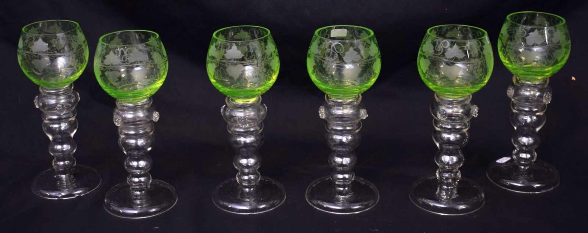 Sechs Weingläserfarbl. Glas, runder Fuß, Kelch mit Weinranken geschliffen verziert, grüner Überfang,