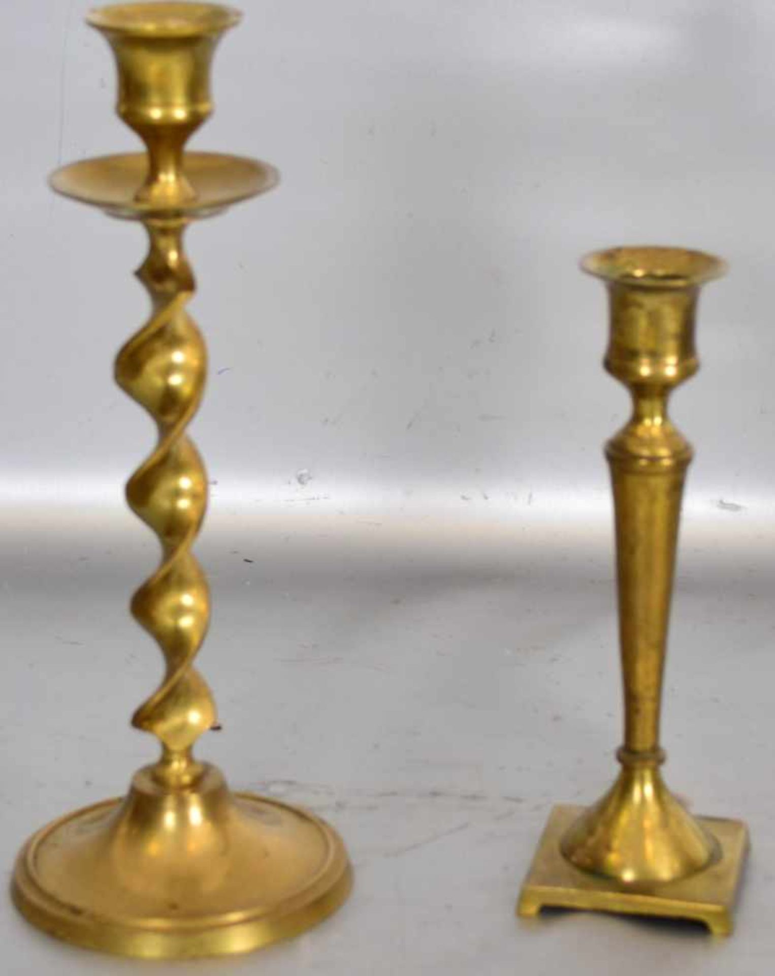 Konvolut zwei TischkerzenleuchterMessing, runder bzw. rechteckiger Fuß, H 24 cm bzw. 17 cm