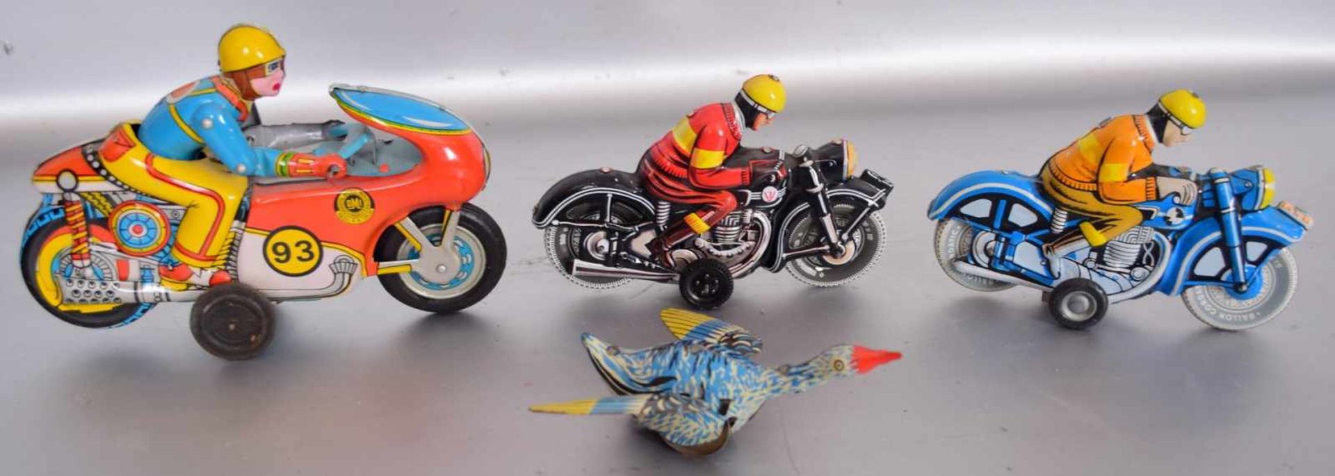 Konvolut BlechspielzeugBlech, bunt bemalt, drei Motorräder und eine Ente, mit Schwungfeder, H 13 cm,