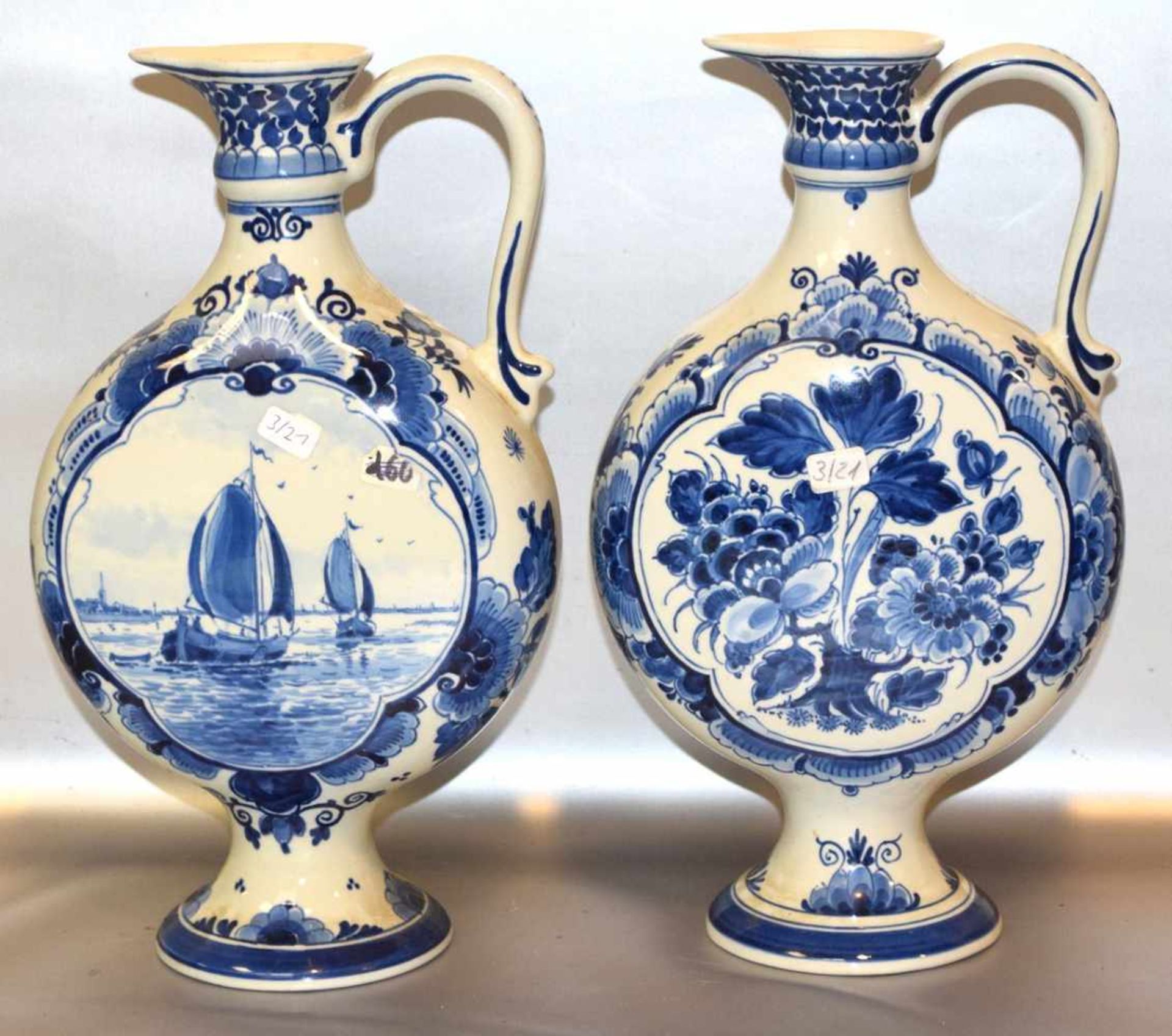 Zwei Vasenbeigefarben, runder Fuß, gebaucht, mit blauer Landschaft bzw. Blumenbemalung, H 29 cm,