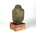 Buddha-Kopf (China)Stein, handgearbeitet; H: ca. 20 cm; auf rot marmoriertem Steinsockel (später);