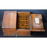 An Edwardian oak slope front desk-top stationery box,