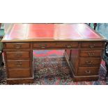 A 20th century mahogany twin pedestal writing desk, the top with tooled and gilt writing surface,