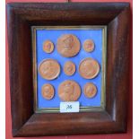 An arrangement of terracotta cameo medallion impressions,