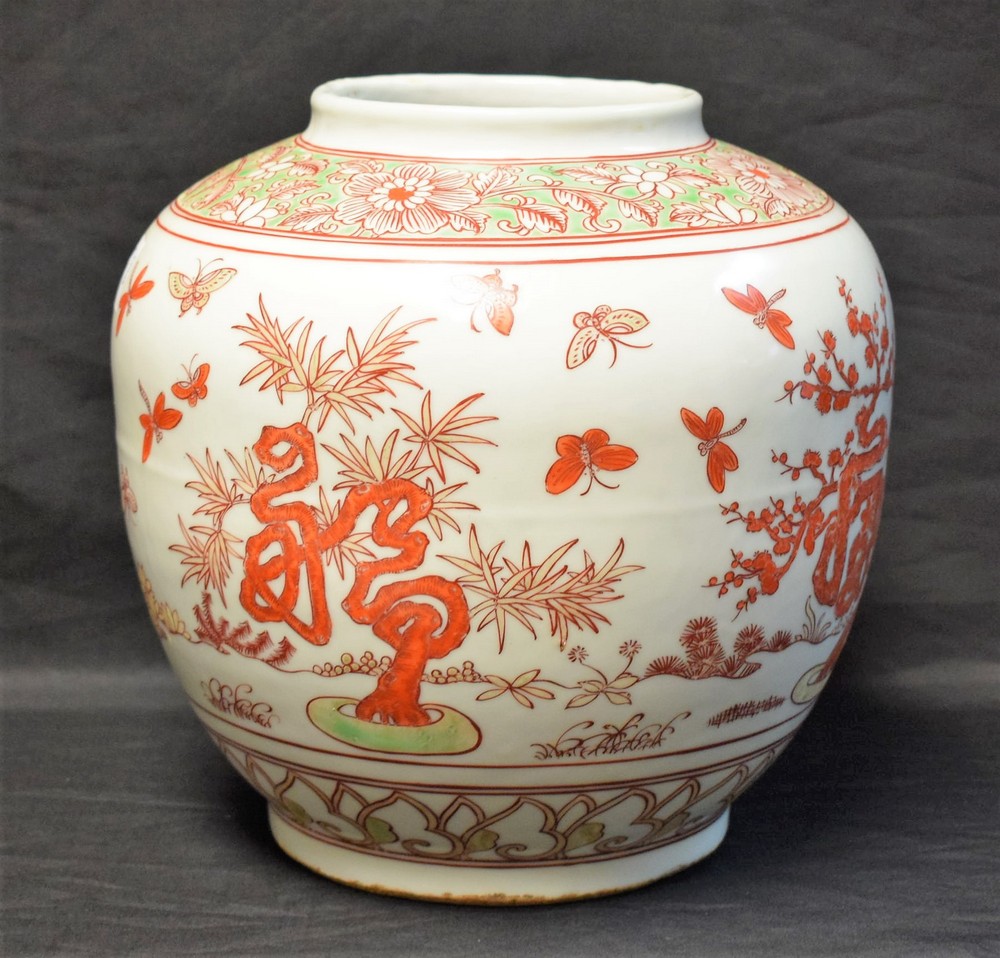 A large Chinese ovoid vase, decorated in red and green with pine trees and insects, 24cm high,