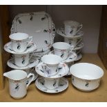 A Shelley Doric shaped part tea service, transfer printed and painted with a stylised thistle motif,