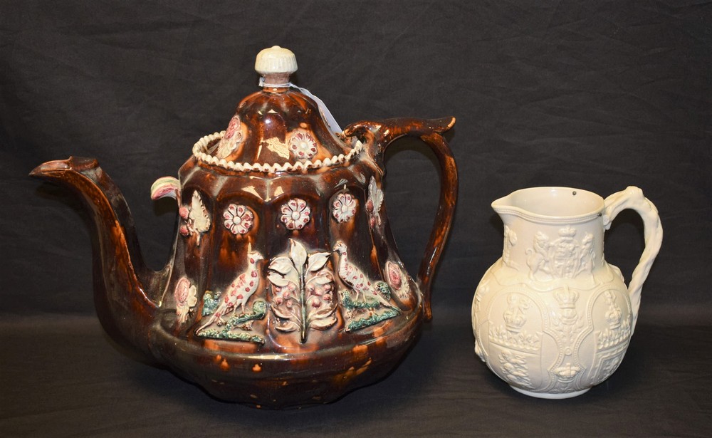 A Victorian Bargeware teapot, relief decorated with pheasants and foliage,