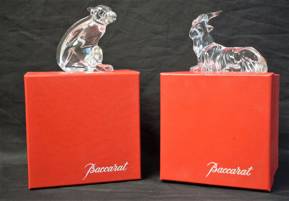 A Baccarat Zodiac Crystal figure, of a monkey, boxed; another, similar, of a seated goat,