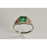 An Art Deco emerald and diamond ring, central cushion cut emerald, approx 6mm x 5.