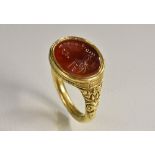 A Romanesque seal stamp ring, intaglio cut with a portrait of a gentleman,