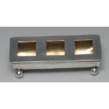 An Edwardian silver three-section stamp box, hinged cover with glazed apertures, ball feet,