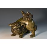 A 19th century Chinese patinated bronze censer, boldly cast as a guardian lion, its mane,