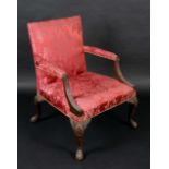 A George III mahogany Gainsborough armchair, serpentine arms, stuffed over damask upholstery,