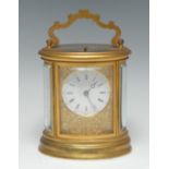 A 19th century gilt brass oval carriage clock,