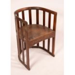 An Arts & Crafts mahogany barrel chair, in the manner of Liberty & Co,