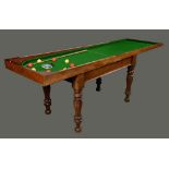 A William IV/early Victorian mahogany bagatelle table, folding top, turned and fluted legs,