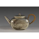 An unusual Aesthetic Movement silver bowed square bachelor's teapot, embossed with lotus,