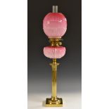 A Victorian opaque cranberry glass and gilt-brass oil lamp, Hinks No.