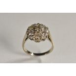 A diamond flower cluster ring, central raised round brilliant cut diamond approx 0.