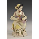 A Bow figure, Allegorical of Autumn, of a girl seated holding a bowl of grapes, 13cm high, c.