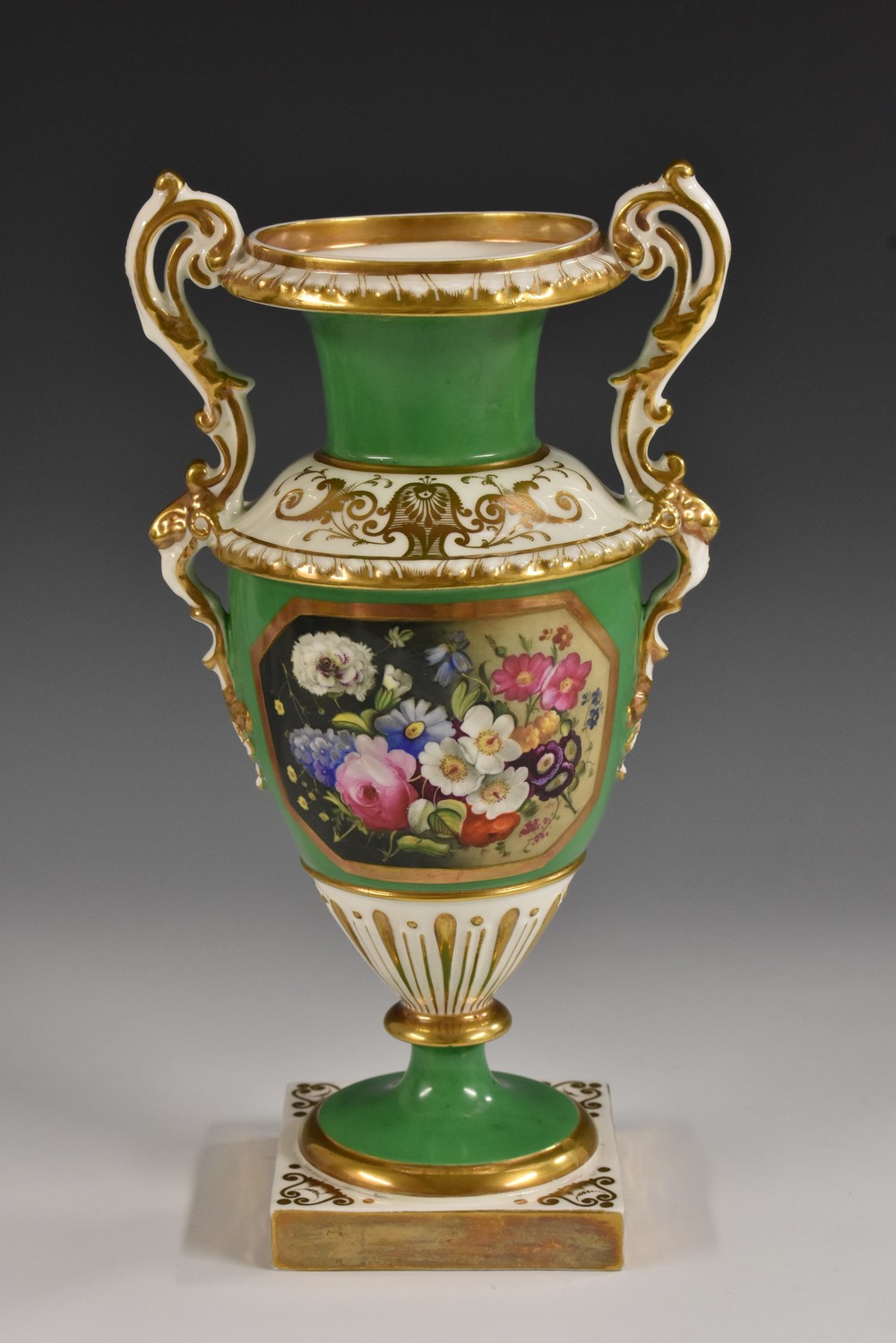 An English porcelain pedestal two handled vase,