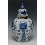 A Dutch Delft lobed ovoid vase and cover, decorated in underglaze blue with stylised flowers,