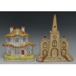 A Staffordshire model of a church, with central spire, in buff, picked out in brown and puce,