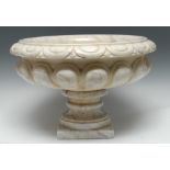 A Grand Tour design marble fluted low urn, dart-and-egg frieze to rim, tuned pedestal, square base,