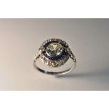 A diamond and sapphire cluster ring, central old brilliant cut diamond approx 1.