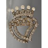 A diamond and pearl intertwined hearts brooch, encrusted with approx seventy eight round,