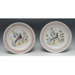 A pair of 19th century circular plates, painted with stylised birds, purple sponged border,