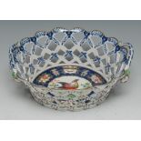 A Worcester type basket, decorated with fanciful bird, on a blue scale ground,