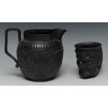 A Wedgwood black basalt Bacchus cup, with vine chaplet, 10cm high, a similar black basalt jug,