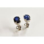 A pair of mid blue sapphire oval earrings, each approx 8mm x 6mm, white metal mount and pillar,