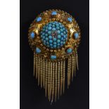 A Victorian Etruscan shield brooch with a central diamond accent within a domed field of turquoise