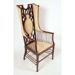 An Art Nouveau period mahogany wingback armchair, the lattice back outlined with satinwood banding,
