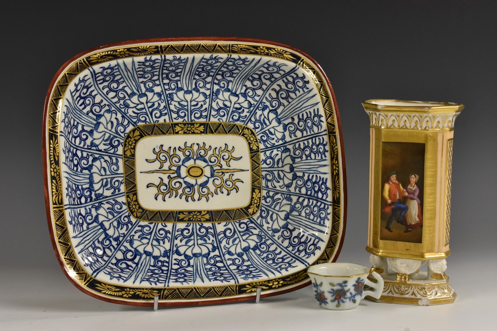 An 18th century miniature toy teacup, decorated with overglaze enamels and underglaze blue,