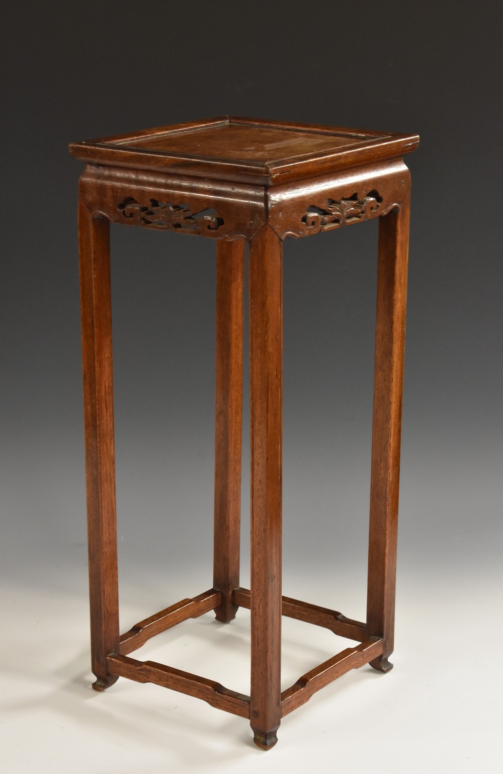 A Chinese hardwood vase stand, square panelled top above a pierced frieze,